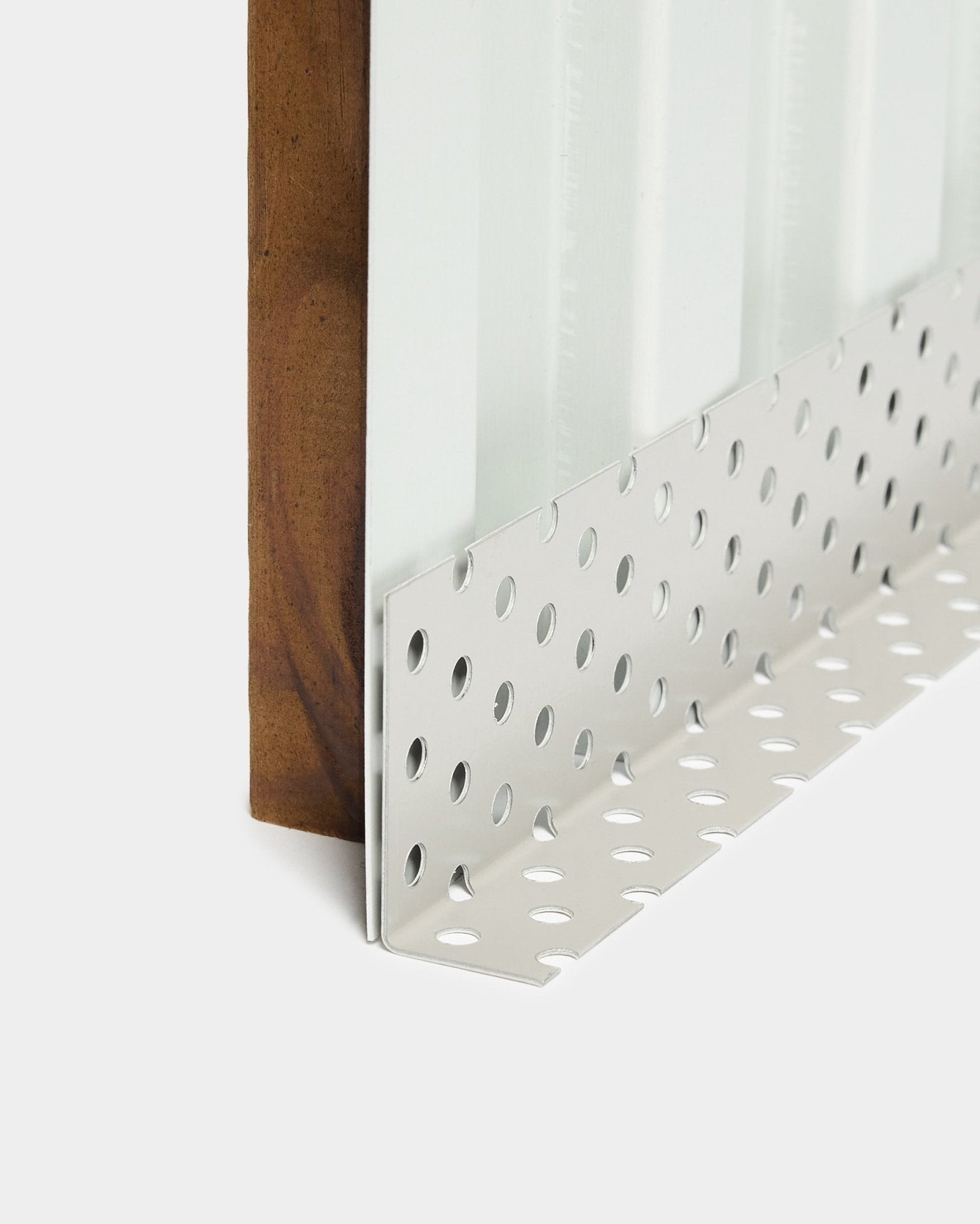 Close-up of Aluwood facade panel installation accessory: metal corner bead with large round perforations, designed for ventilated cavities, 240 cm length.